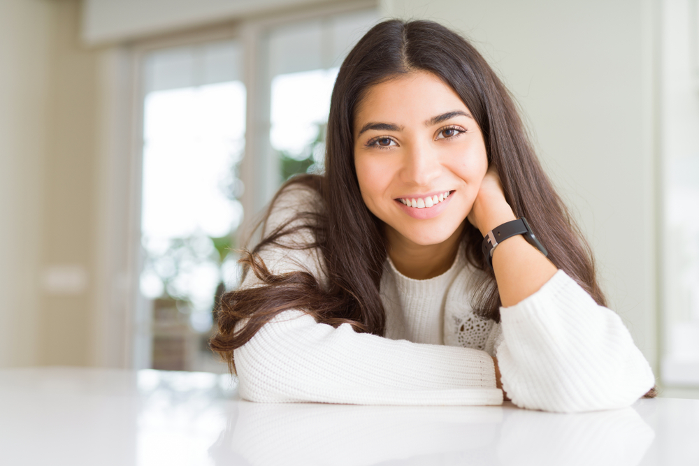 Three women smiling together representing confidence, joy, and positive dental experiences – dentist williamsville ny