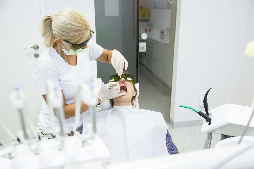 Three women smiling together representing confidence, joy, and positive dental experiences – dentist williamsville ny